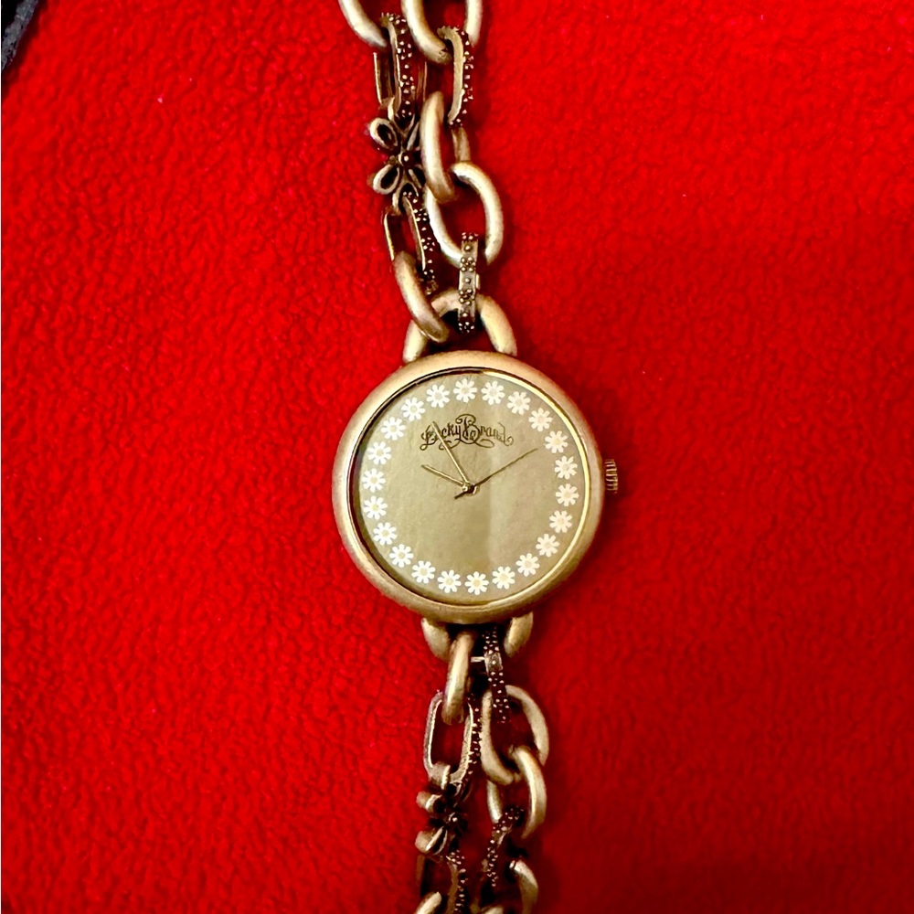 Silver Lucky Brand bracelet watch with daisy flowers face. Needs battery.
